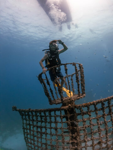 Camper underwater with a sunken boat.