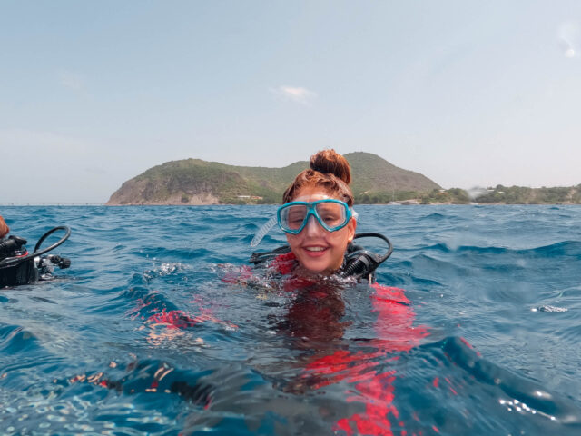 Camper in the water with dive gear.