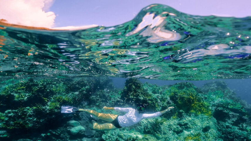Camper swimming underwater.