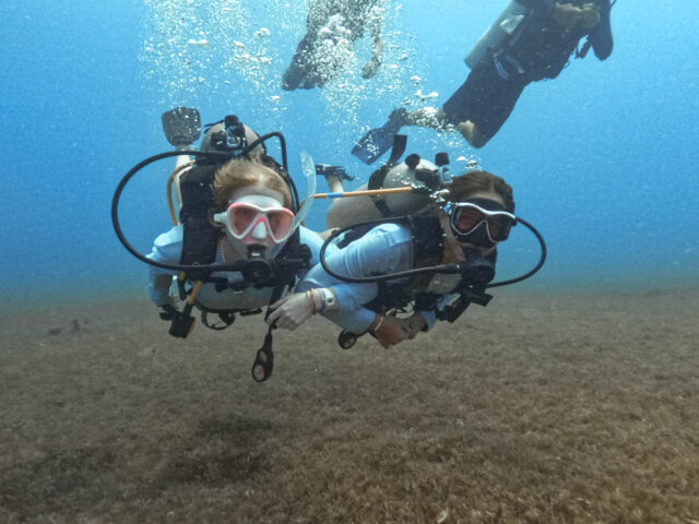 Two campers scuba diving together.