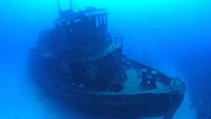 A boat under water with a boat in the water.