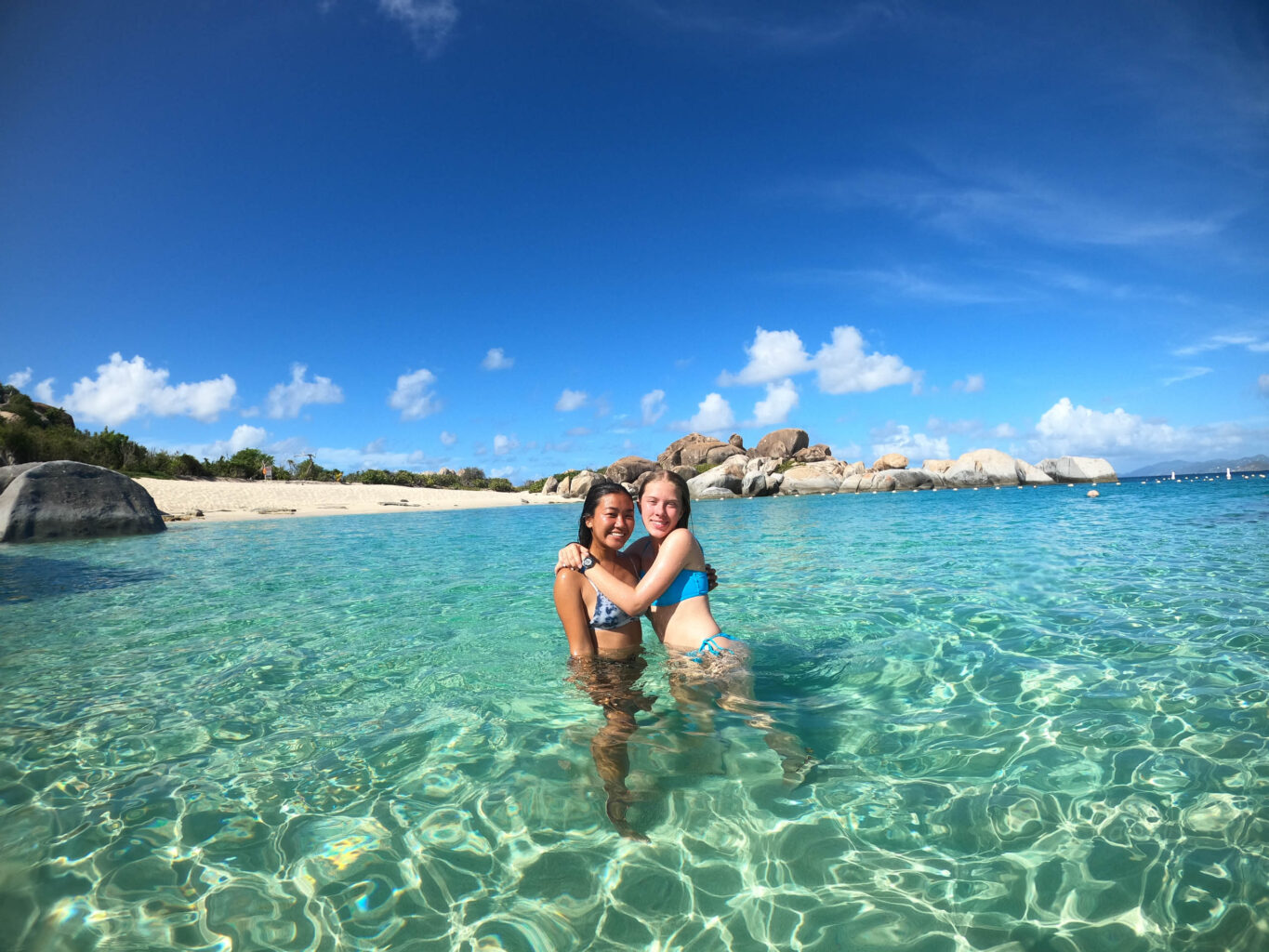 Two girls in shallow water together.