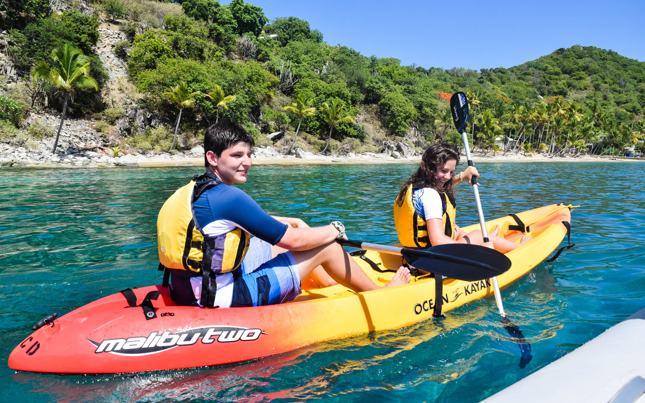 Two people on a kayak in the water.