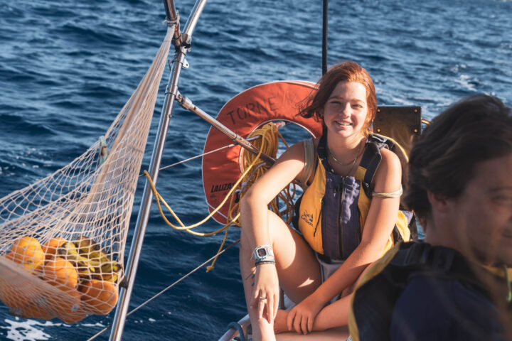 A woman and a man on a sailboat.