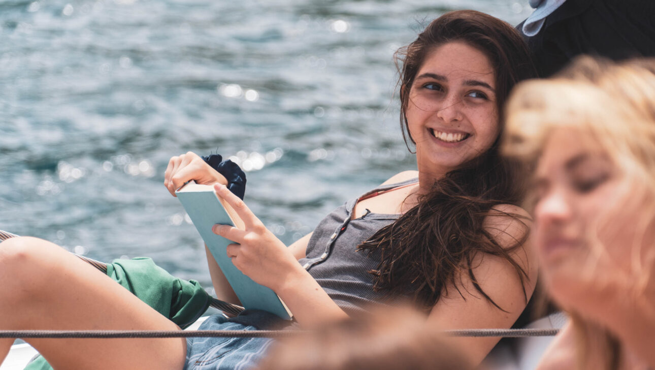 Camper reading on the boat.