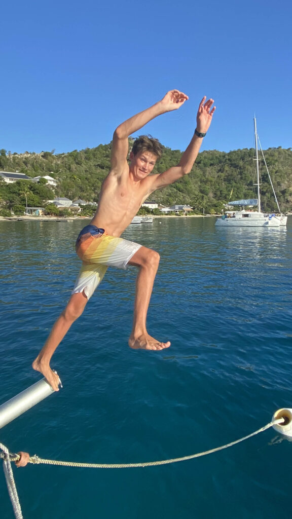 Boy jumping into the ocean.