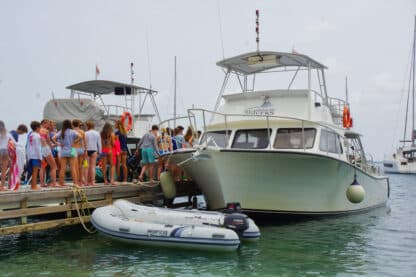 Teens getting ready to dive off of custom dive boats in the caribbean